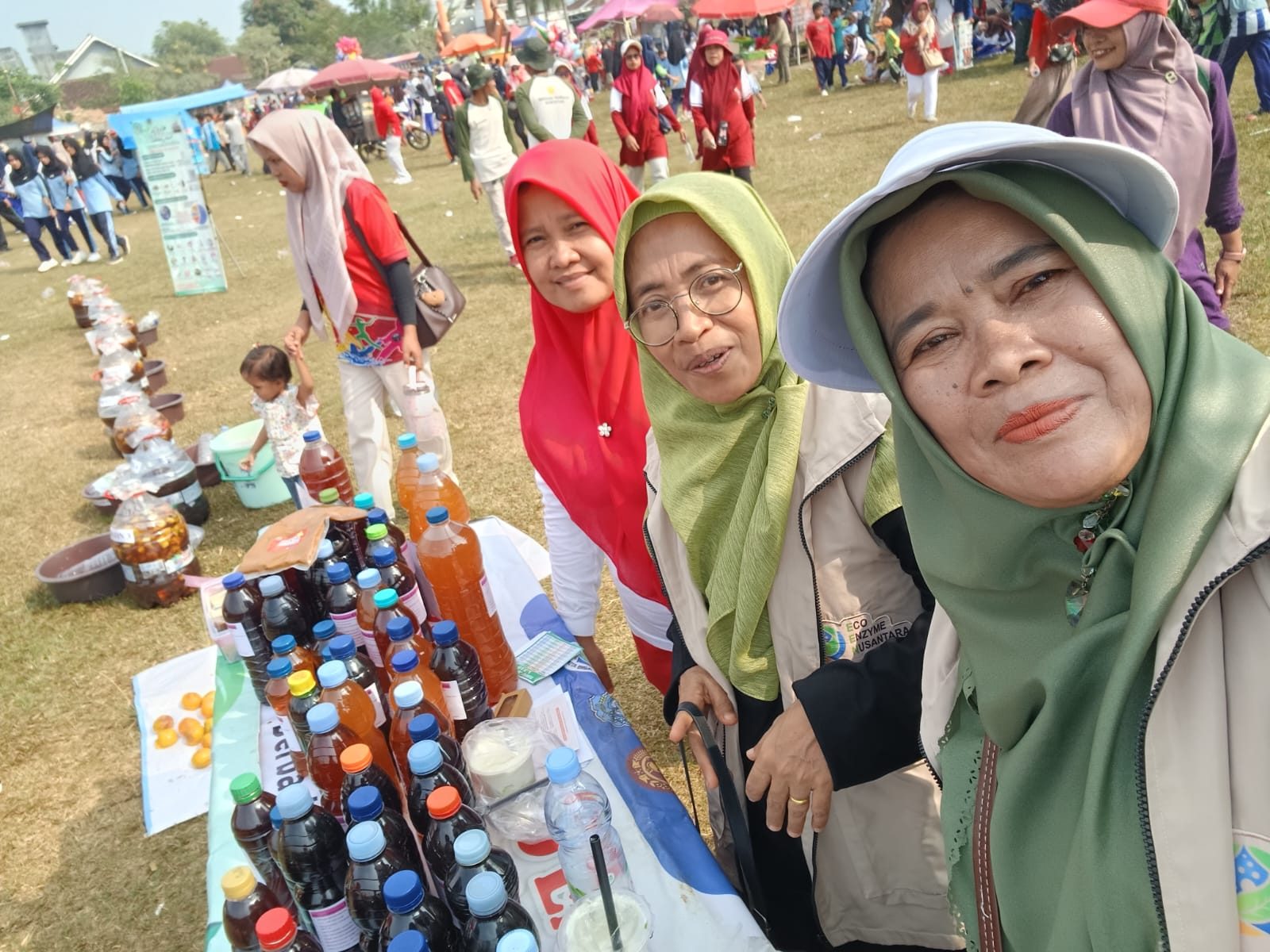 Relawan Eco Enzyme Nusantara Kabupaten Lampung Timur di stan pameran, dengan puluhan botol hasil fermentasi yang siap dibagikan kepada warga. Foto: Panitia HUT RI
